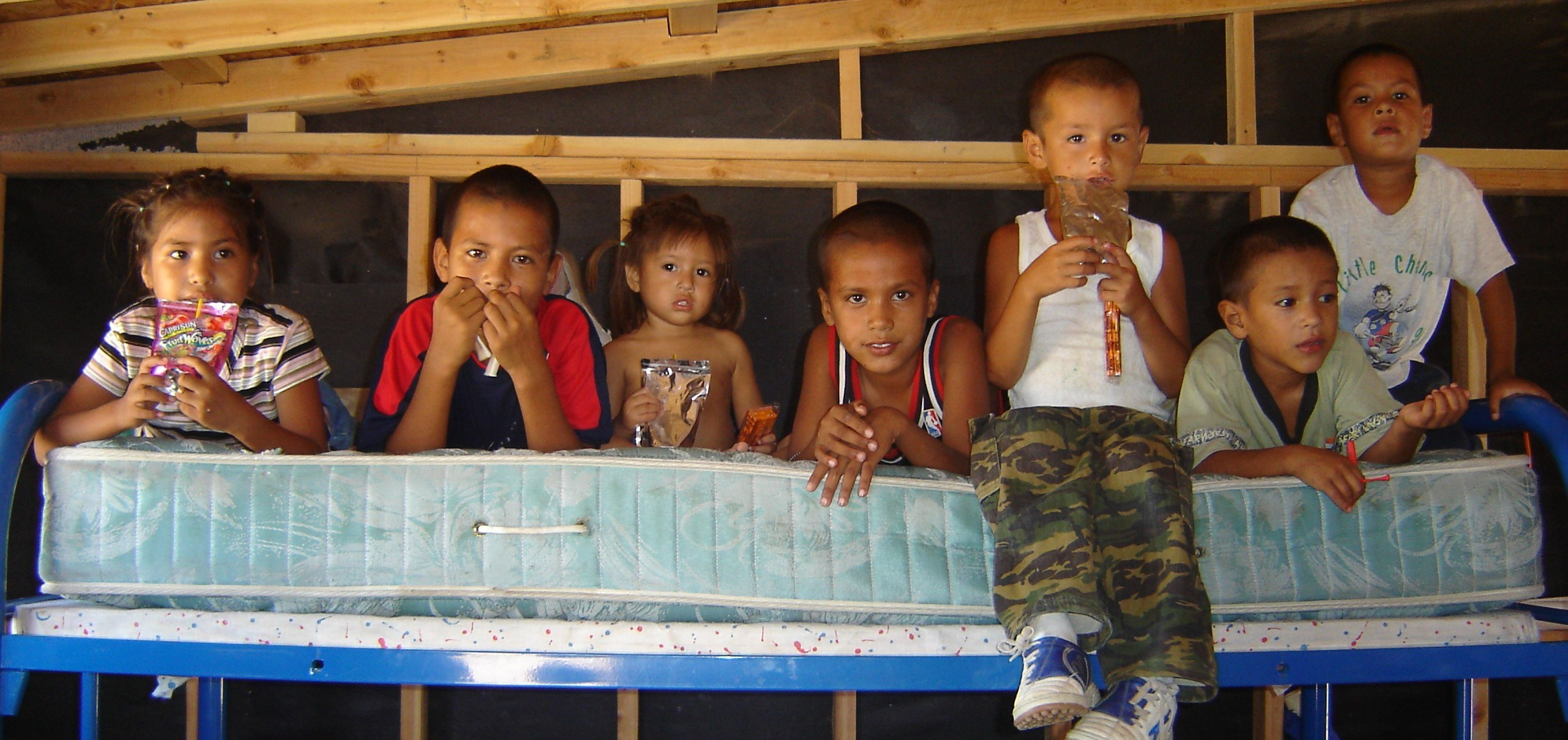 Children sitting on a mattress